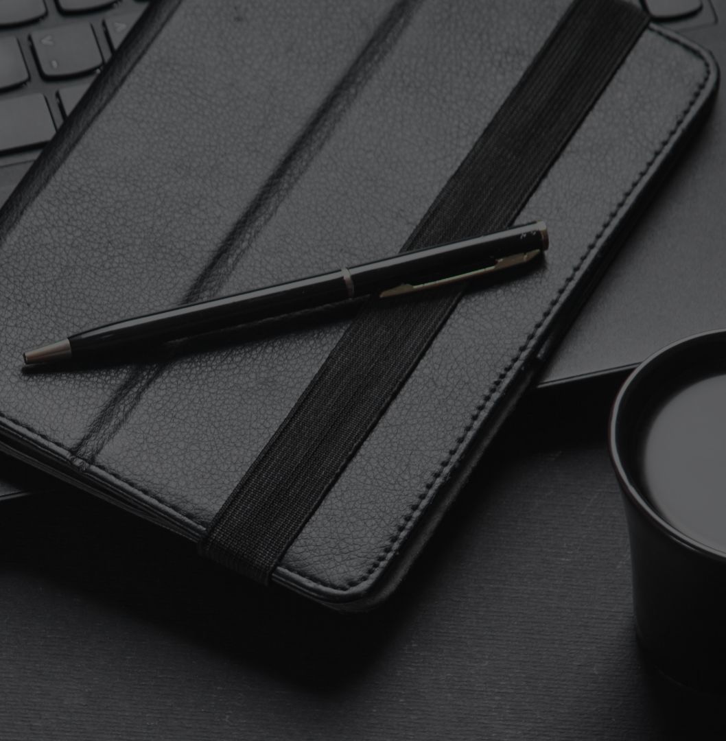 Marketing planning desk with a leather notebook, pen and coffee